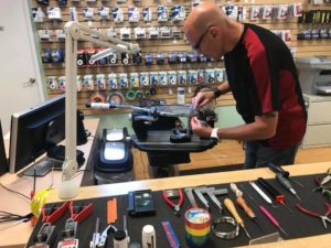 A racquet stringer stringing racquets in our Calgary store
