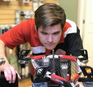 Coach Jarod stringing a racquet in our Calgary store