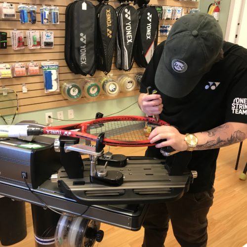 Coach Jarod stringing tennis racquets in our Calgary store.